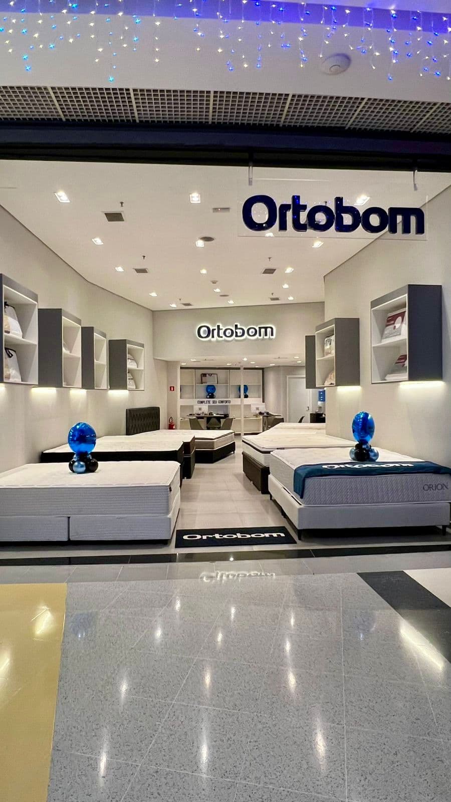 Logo da loja ortobom colchões